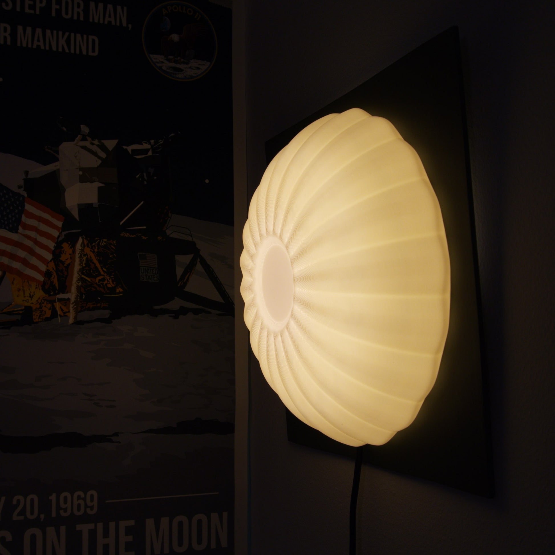 Wall-mounted illuminated Kueh Tutu lamp glowing alongside a decorative poster, highlighting its use as ambient wall decor