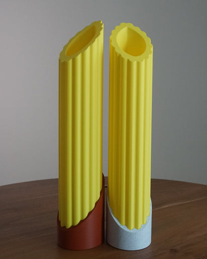 Two penne pasta lamps unlit in bright daylight